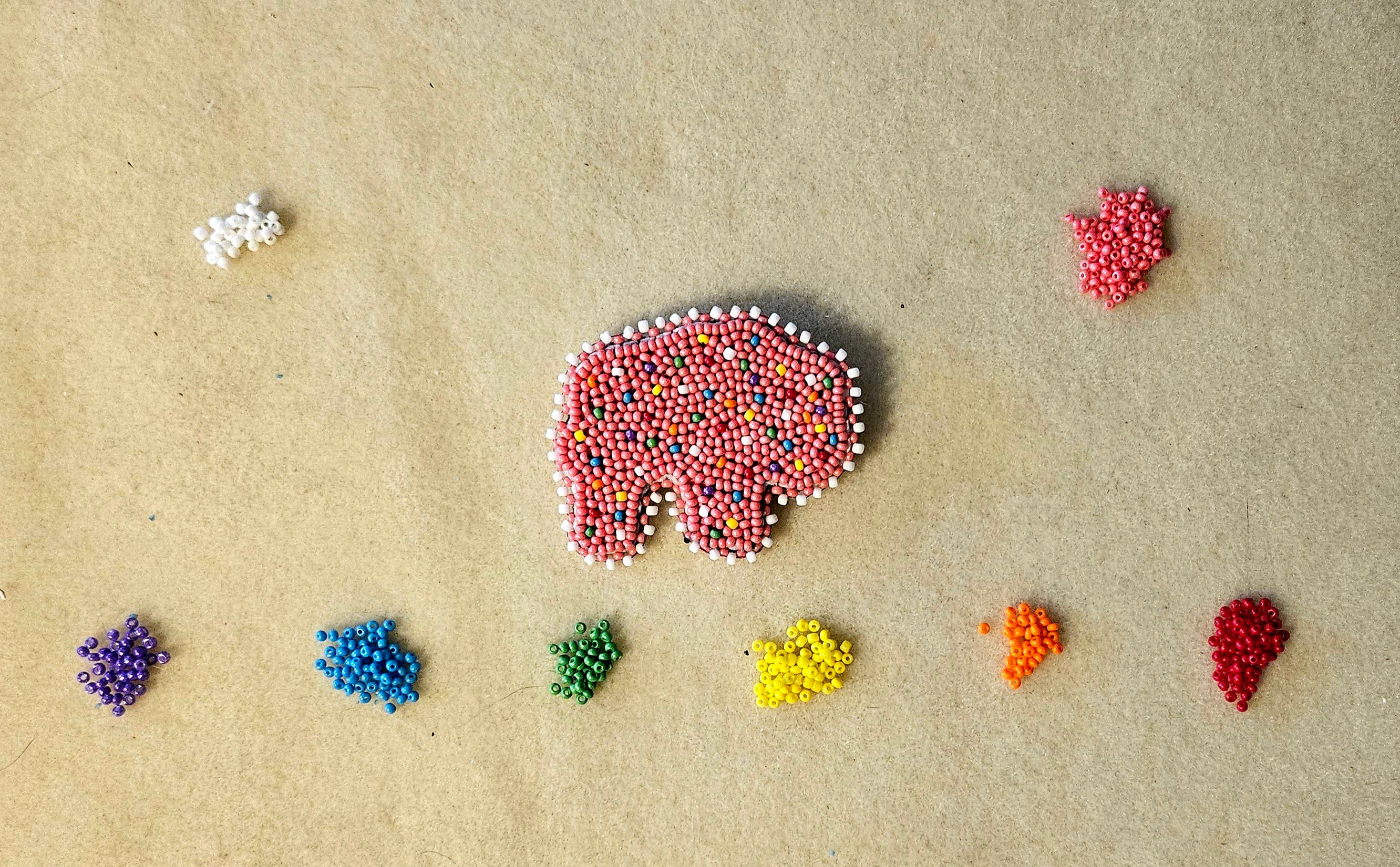 Colorful bead patterns on a beige surface